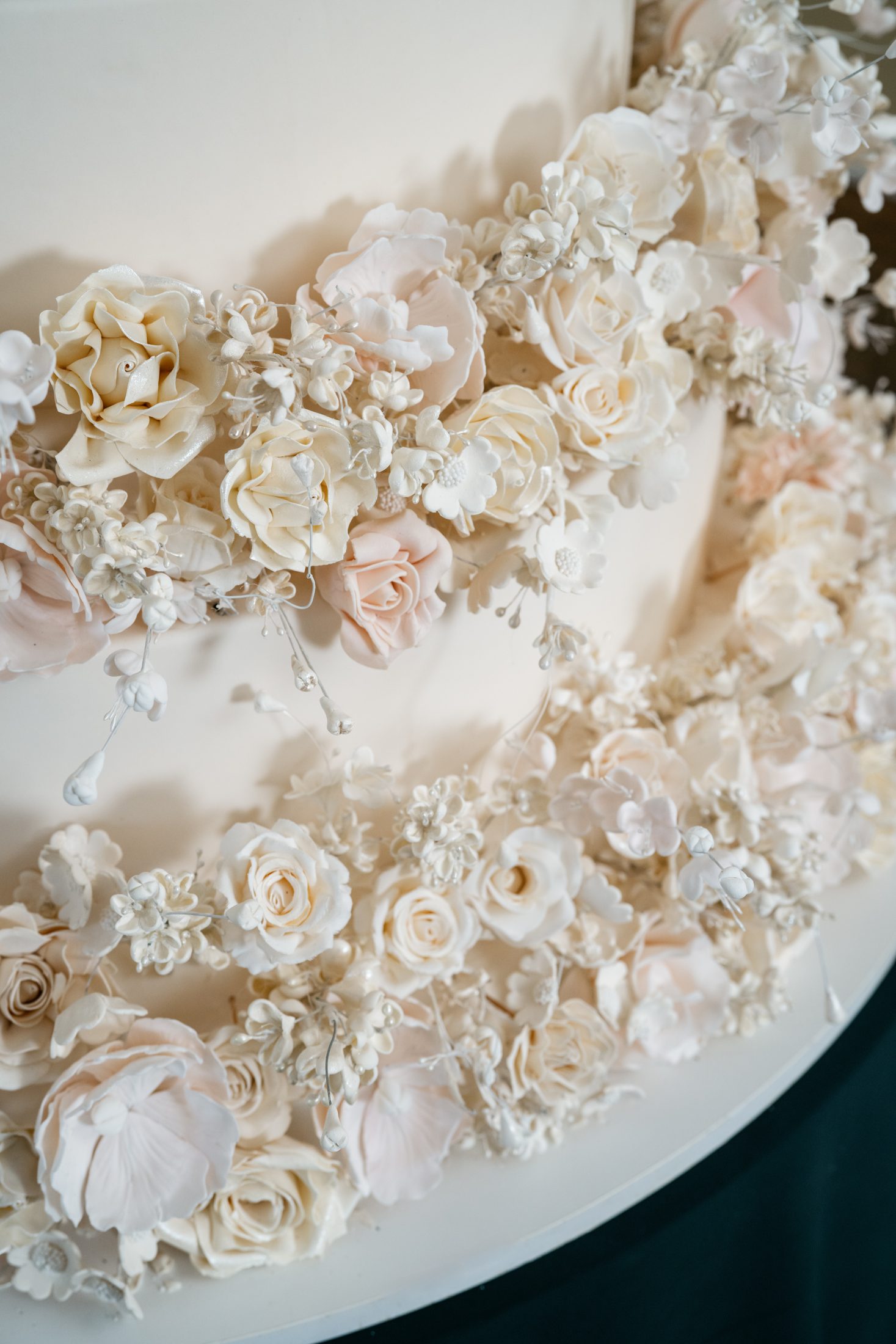 Close-up of hand-made ivory and blush sugar flowers